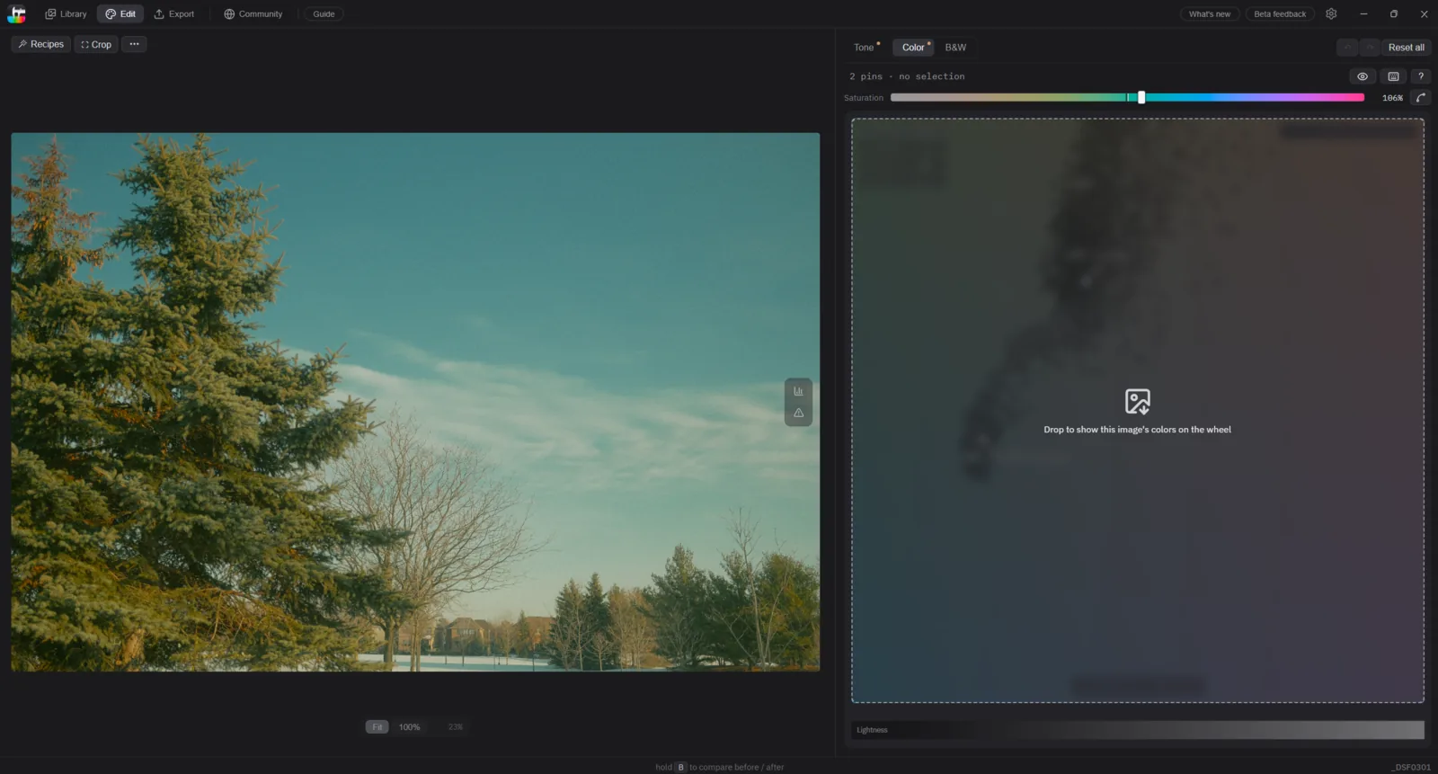 The editor mid-drag: the photo being edited fills the left side, while on the right the color wheel is covered by a dashed drop zone showing an image icon and the line 'Drop to show this image's colors on the wheel'.
